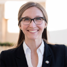 Smiling woman with glasses in a business suit