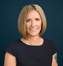 Smiling blonde woman in a professional top